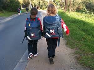 Two children walk to school together.